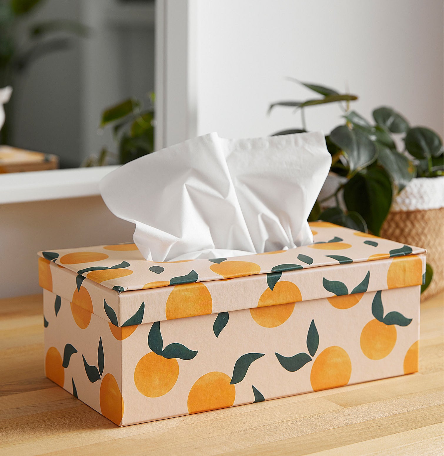 a tissue box holder with tissues inside on a table