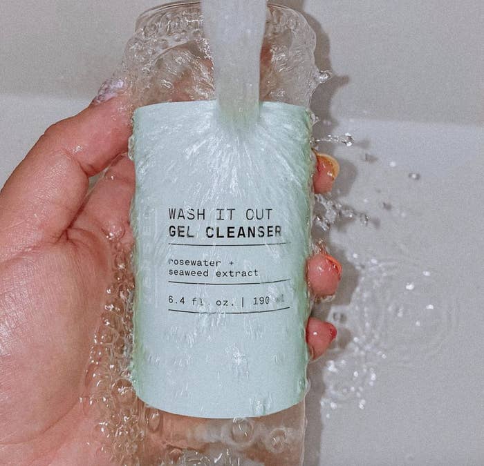 The Versed wash it out gel cleanser in a clear bottle with a blue tint