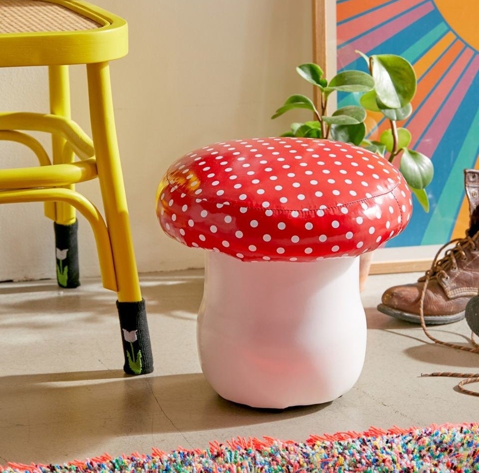 a stool with a white bottom and red polka-dot top that looks like a mushroom