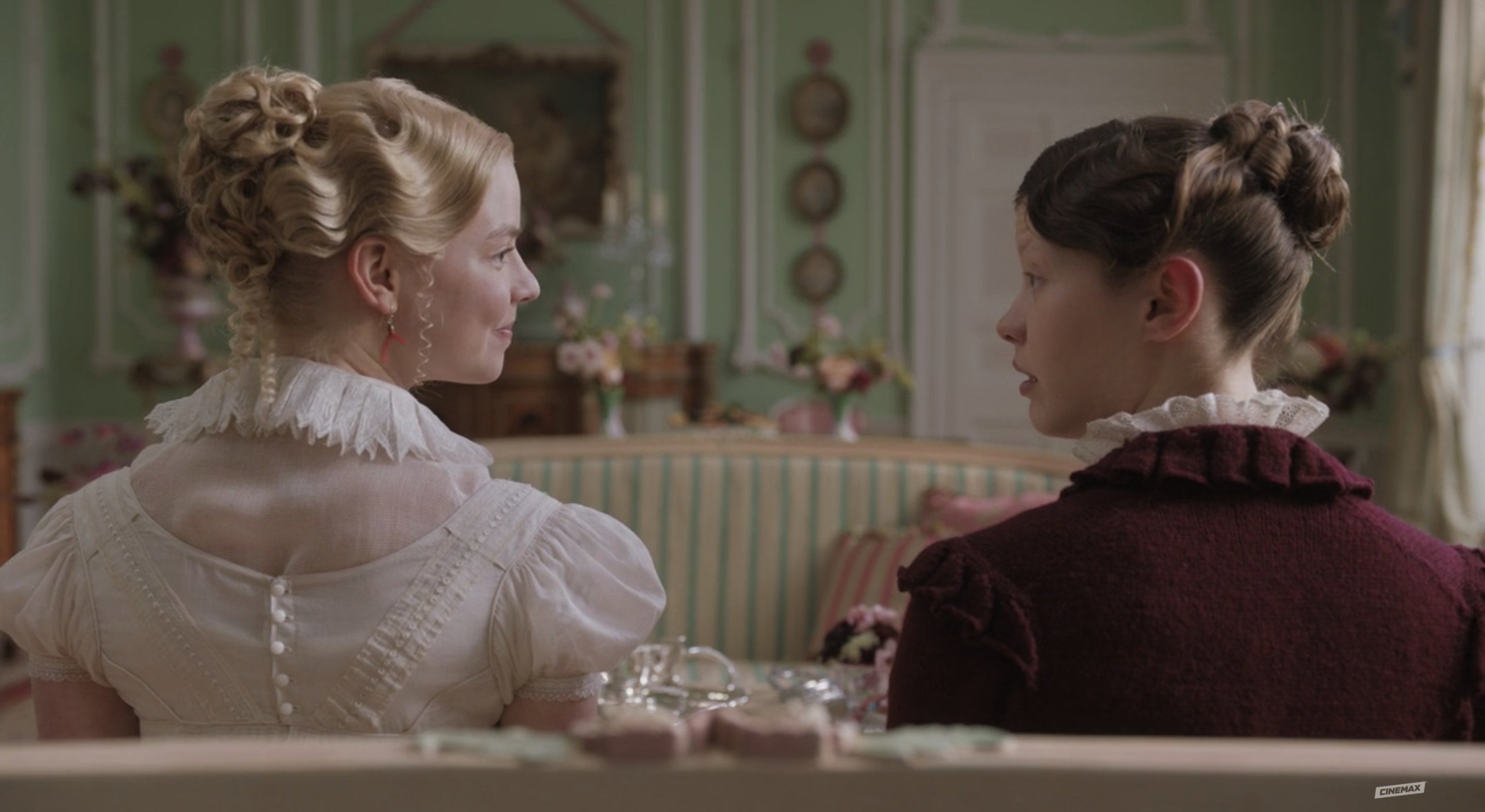 Emma and Harriet turn and face in other in conversation