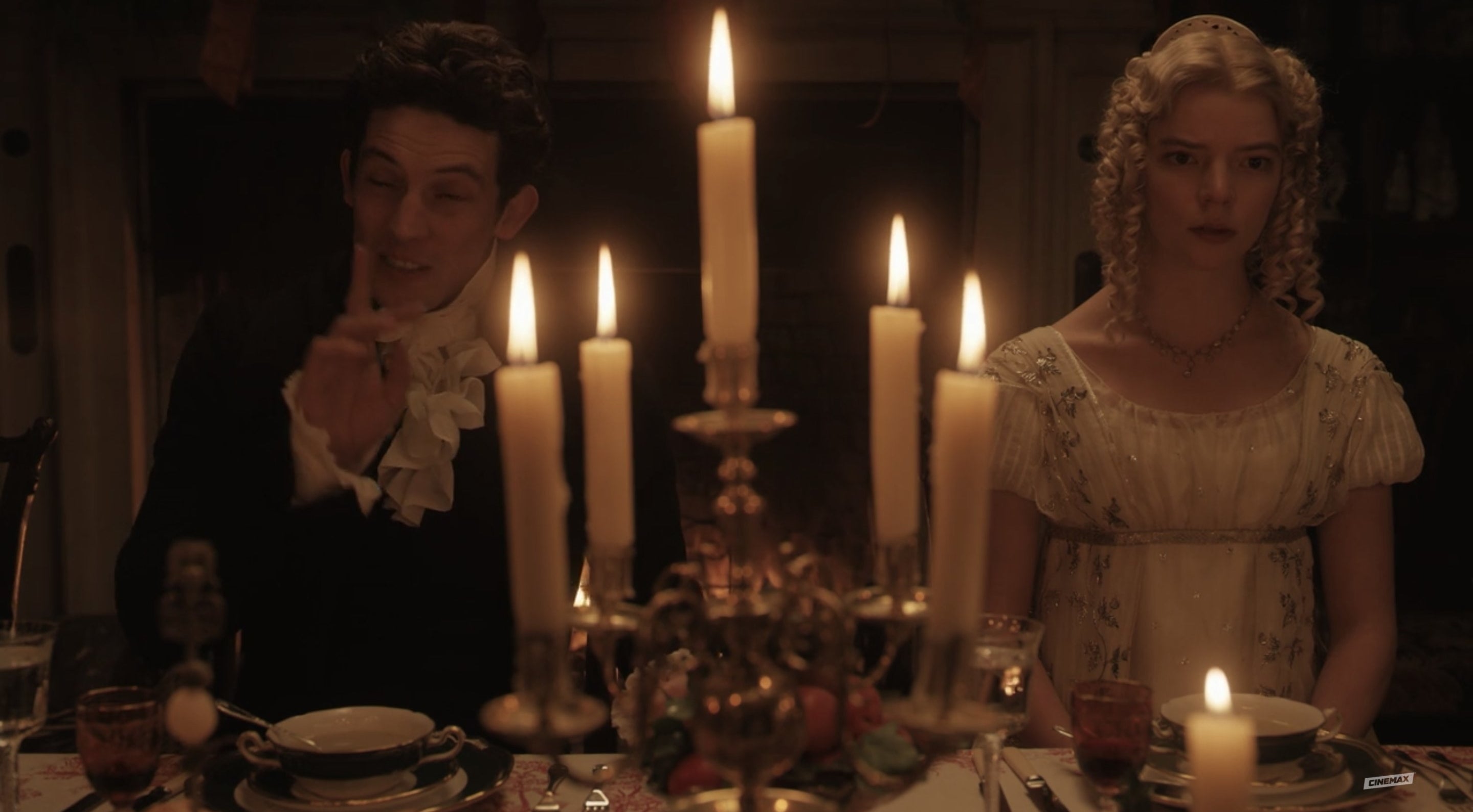 Emma looks especially over it at dinner as she sits next to the vicar, a candle separating the two