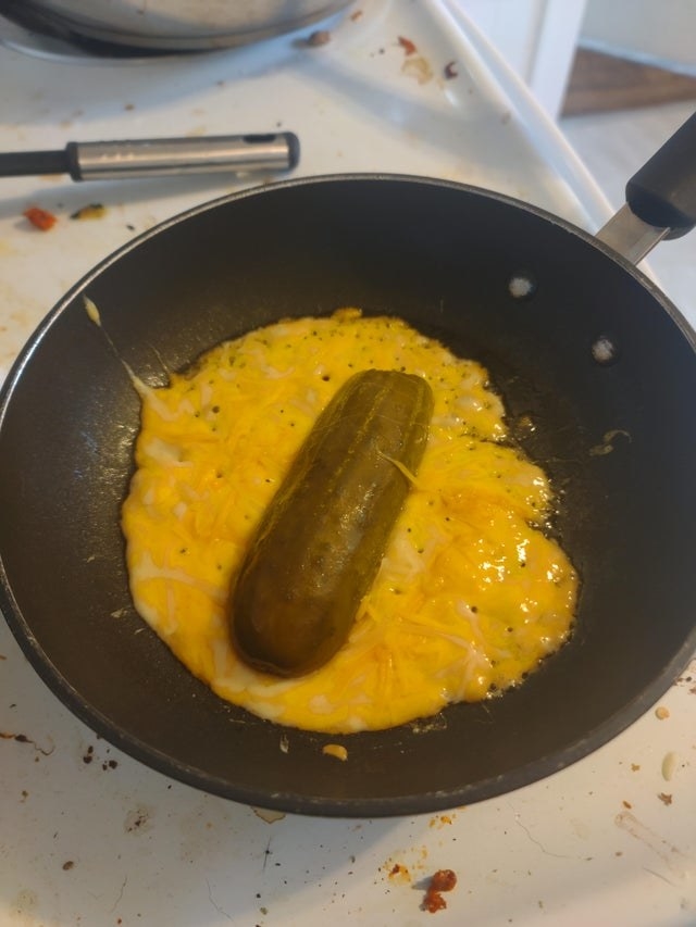 A cheesy pickle wrap in a pan