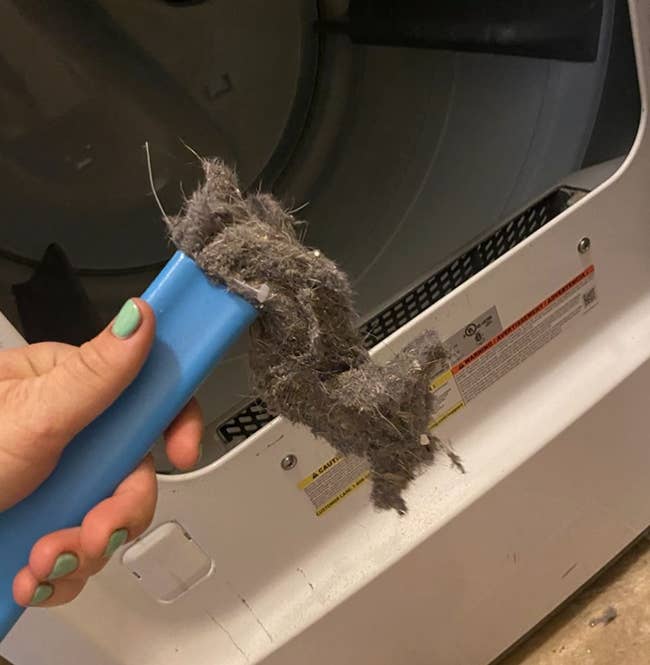 A customer review photo of the dryer vent cleaner filled with the dirt it collected