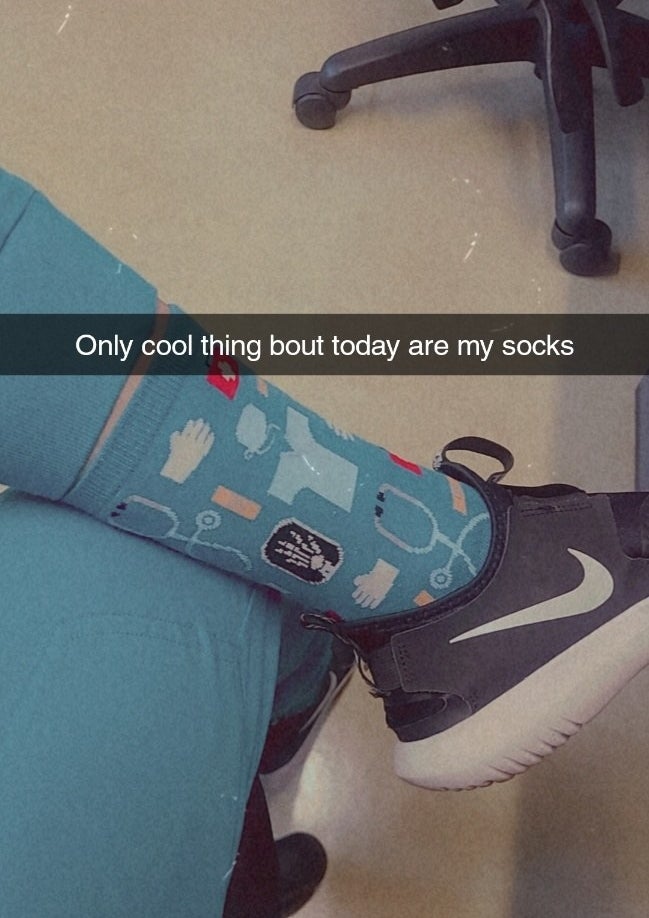 reviewer Snapchat photo wearing the socks with caption, &quot;Only cool thing bout today are my socks&quot;