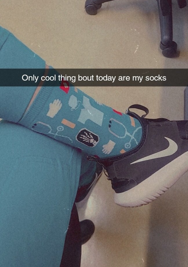reviewer Snapchat photo wearing the socks with caption, "Only cool thing bout today are my socks"