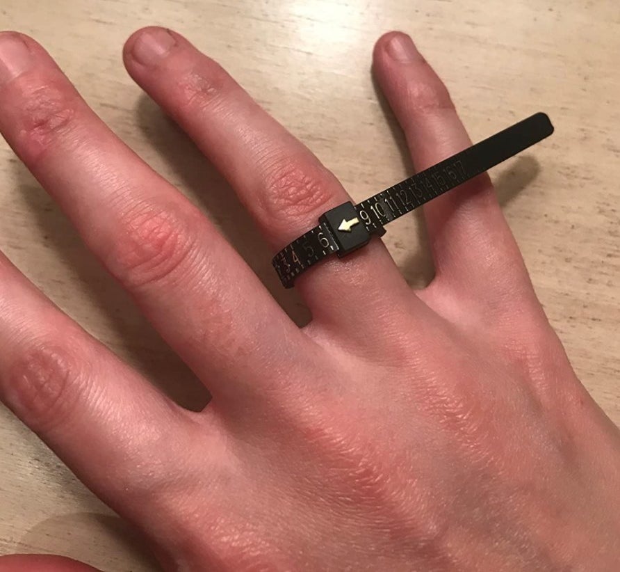 the ring sizer on a reviewer's hand
