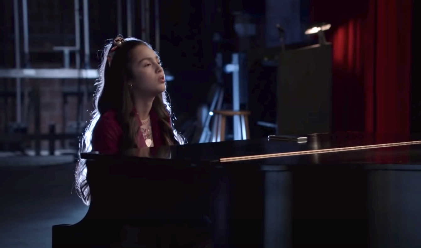 olivia rodrigo sings on a piano