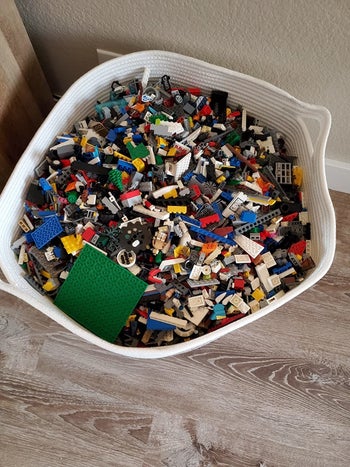 Reviewer's up-close photo showing the brown and beige rope basket holding legos