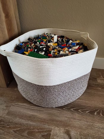 Reviewer's photo showing the brown and beige rope basket holding legos