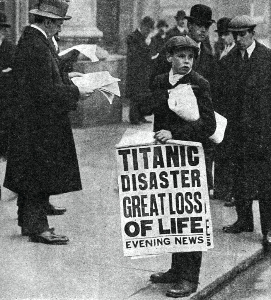 A little boy holding a newspaper that reads &quot;Titanic Disaster Great Loss of Life&quot;