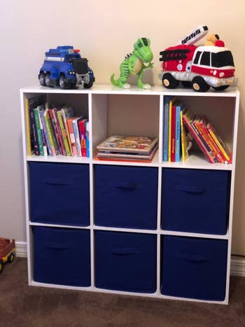 Reviewer's photo showing the blue fabric storage cubes in their shelving unit