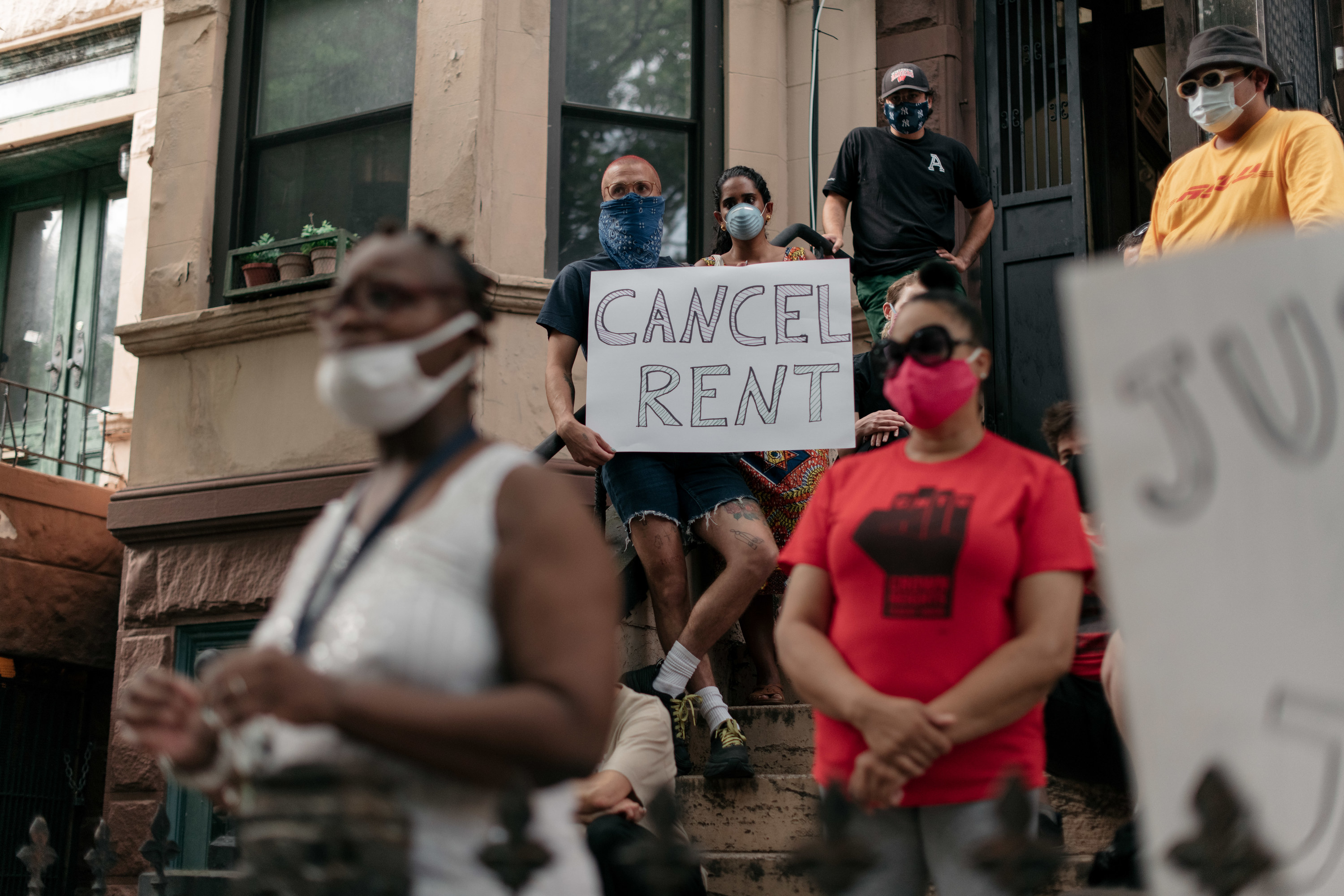 Protesters with a sign that reads cancel rent