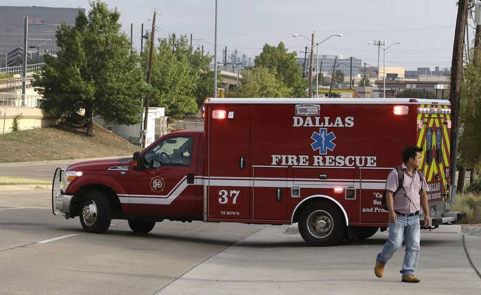 An ambulance with its lights on pulls out from Dallas Fire-Rescue Station 37