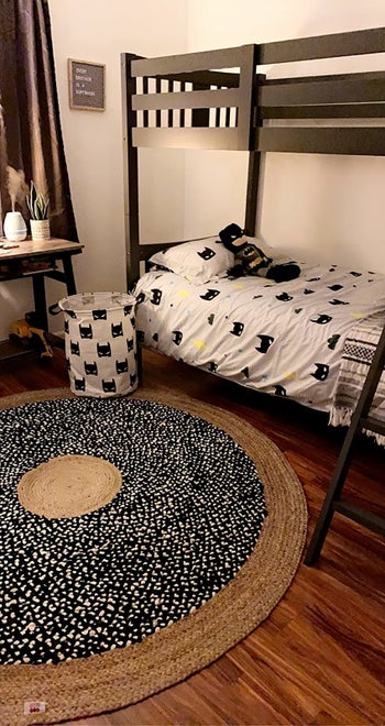 Reviewer's photo showing the canvas bin in bat print in their child's bedroom