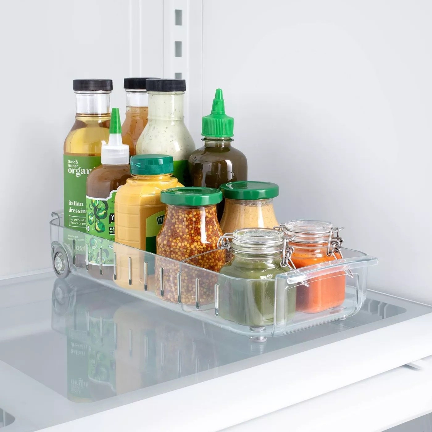 A clear roll-out fridge caddy.