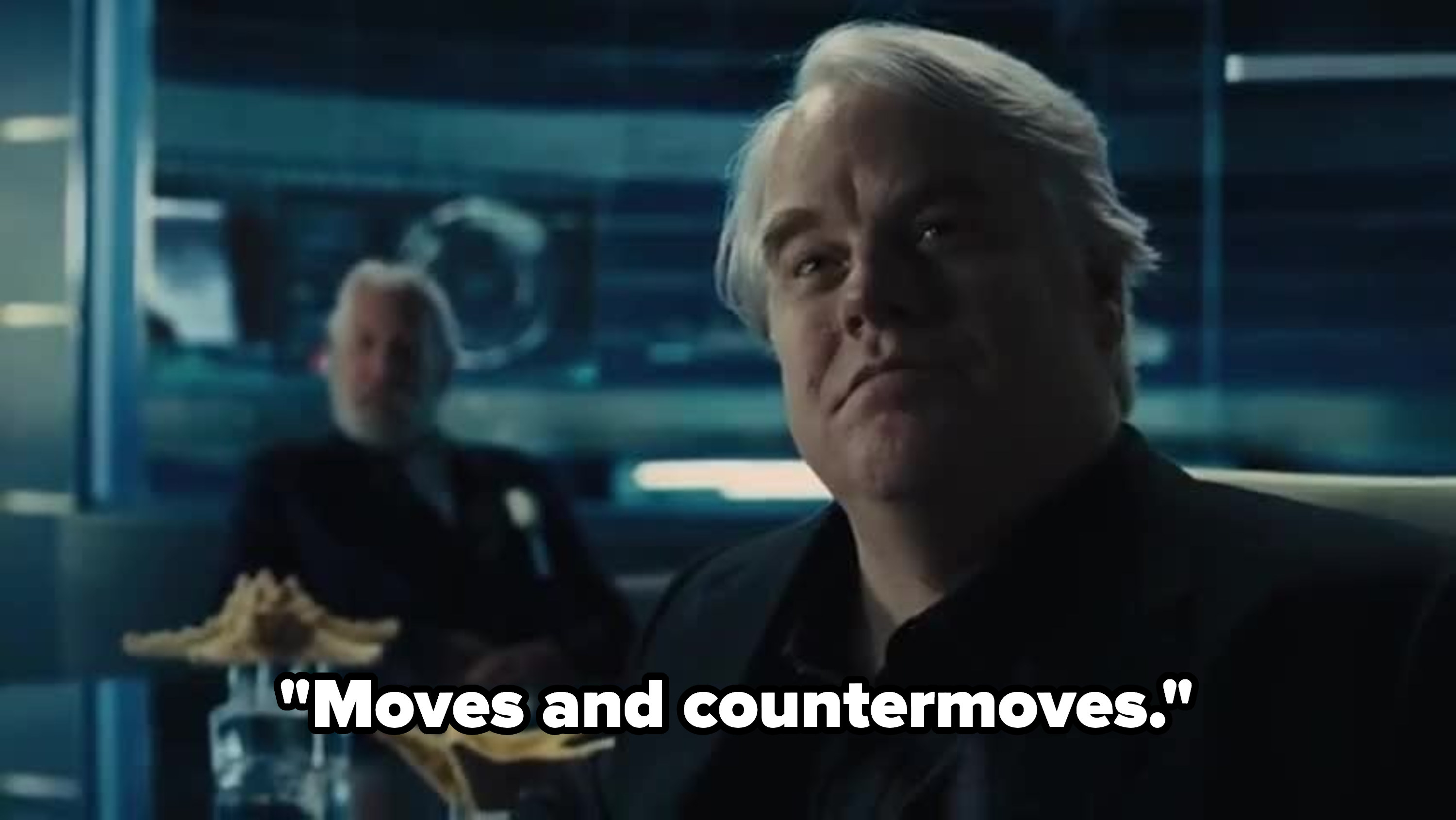Plutarch watching the games with President Snow