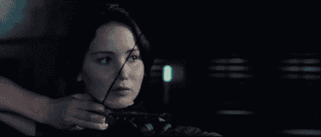 Katniss hitting her target with her arrow