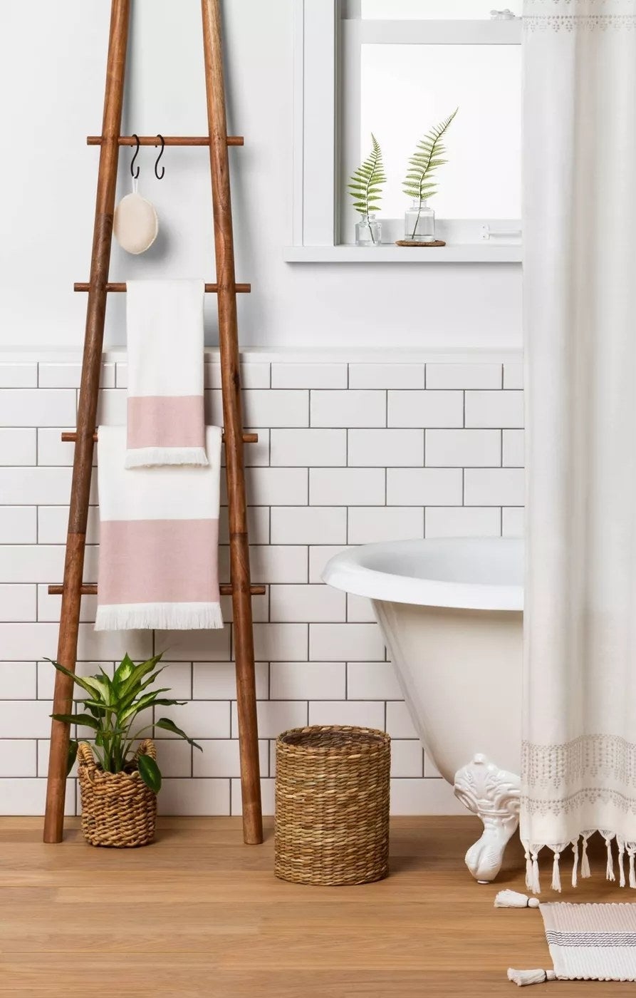 The ladder with four rungs holding towels in a bathroom