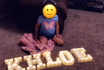 Reviewer's photo showing the marquee letter lights spelling out their child's name