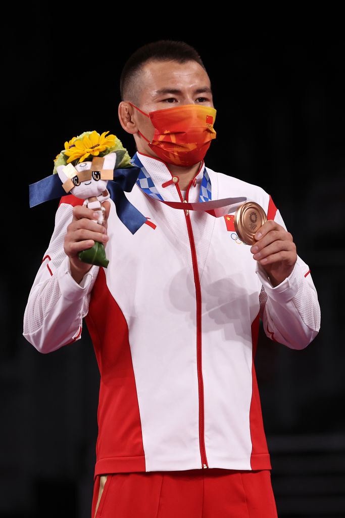 Sailike Walihan of Team China poses with the bronze medal and flowers during the Victory Ceremony