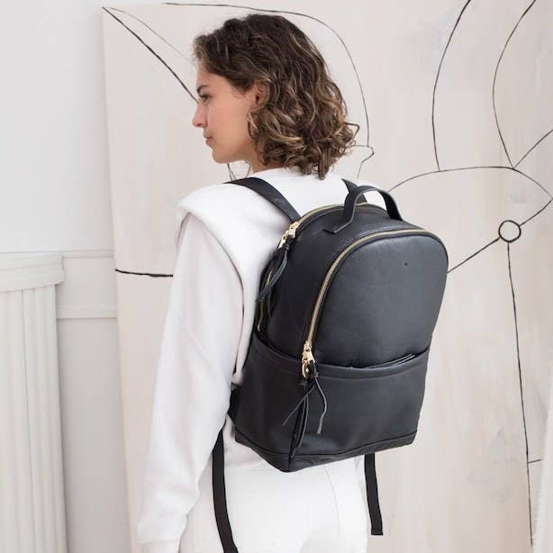 a person wearing a leather backpack