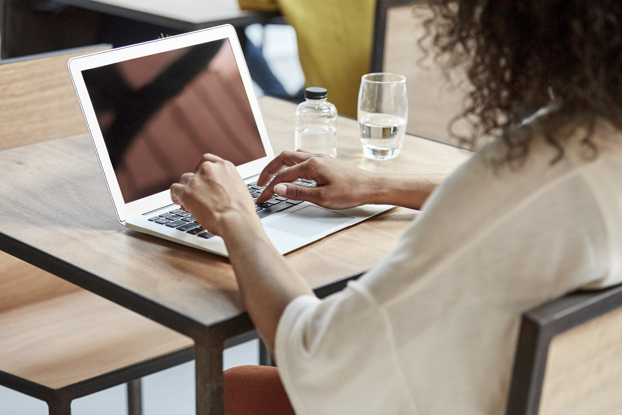 A woman booking a reservation on her laptop