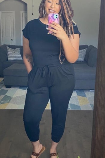 Reviewer wearing black jumpsuit