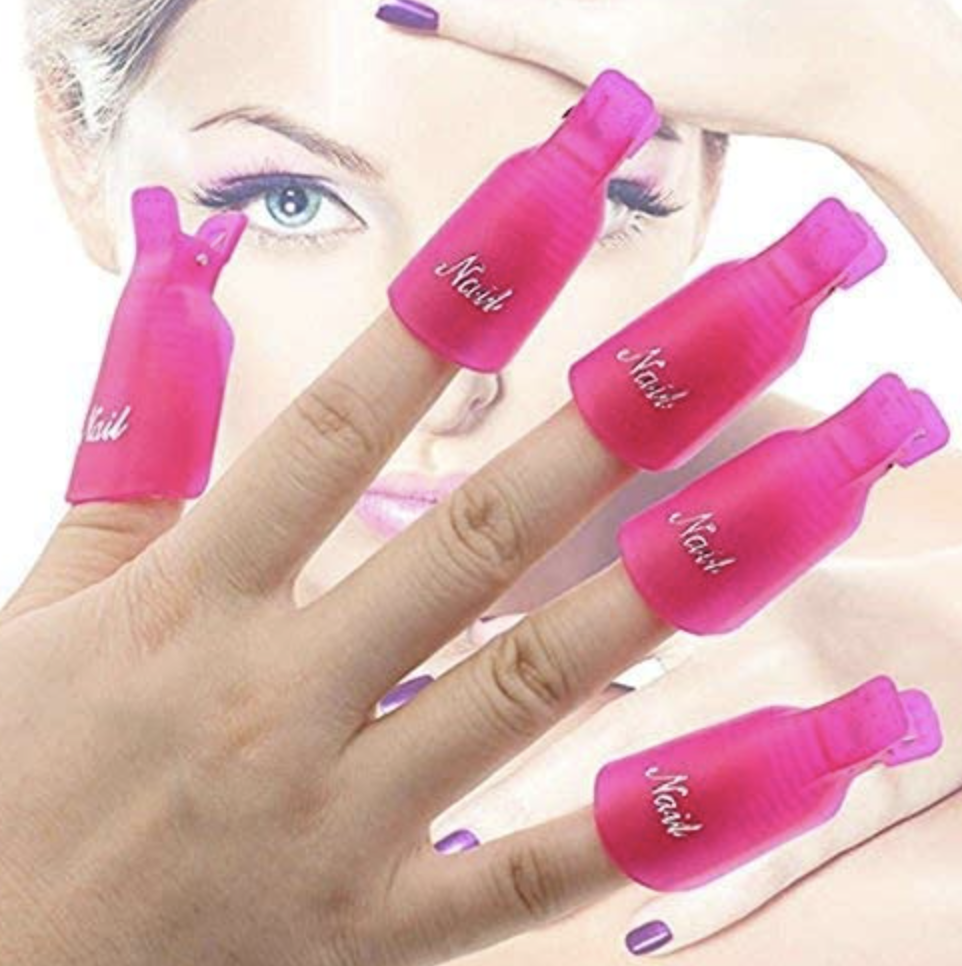 hand with nail varnish remover clips