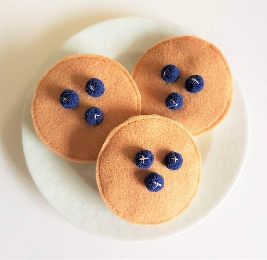 Three pancake cat toys on a plate