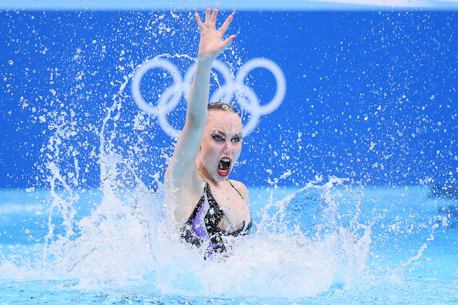 A woman swimmer performs in the pool at the Tokyo Olympics