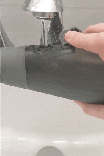 a gif of a hand filling the flosser water tank from the sink 