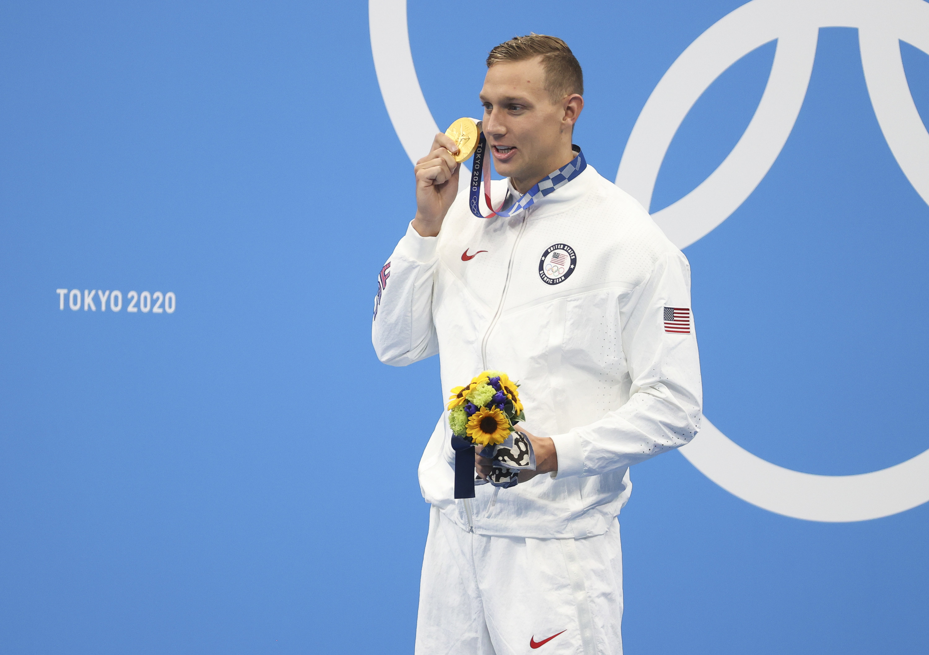 Caeleb Dressel holding up his gold medal during the medal ceremony of the Men&#x27;s 50m Freestyle Final