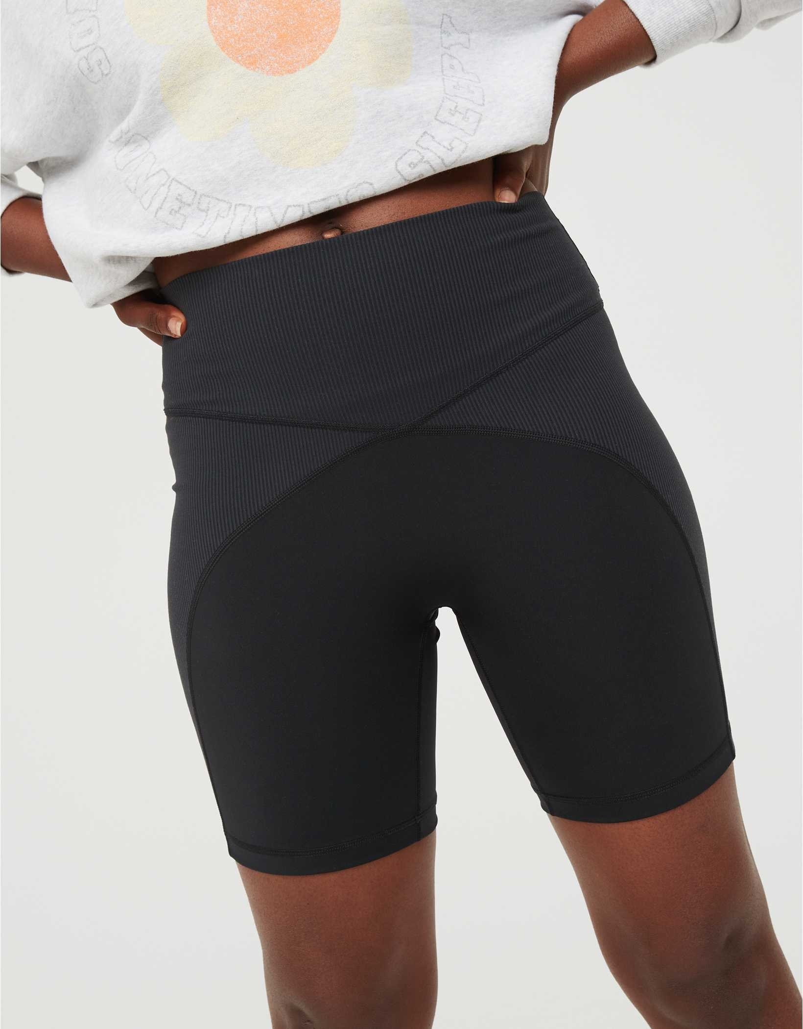 model wearing the black ribbed bike shorts and crop top