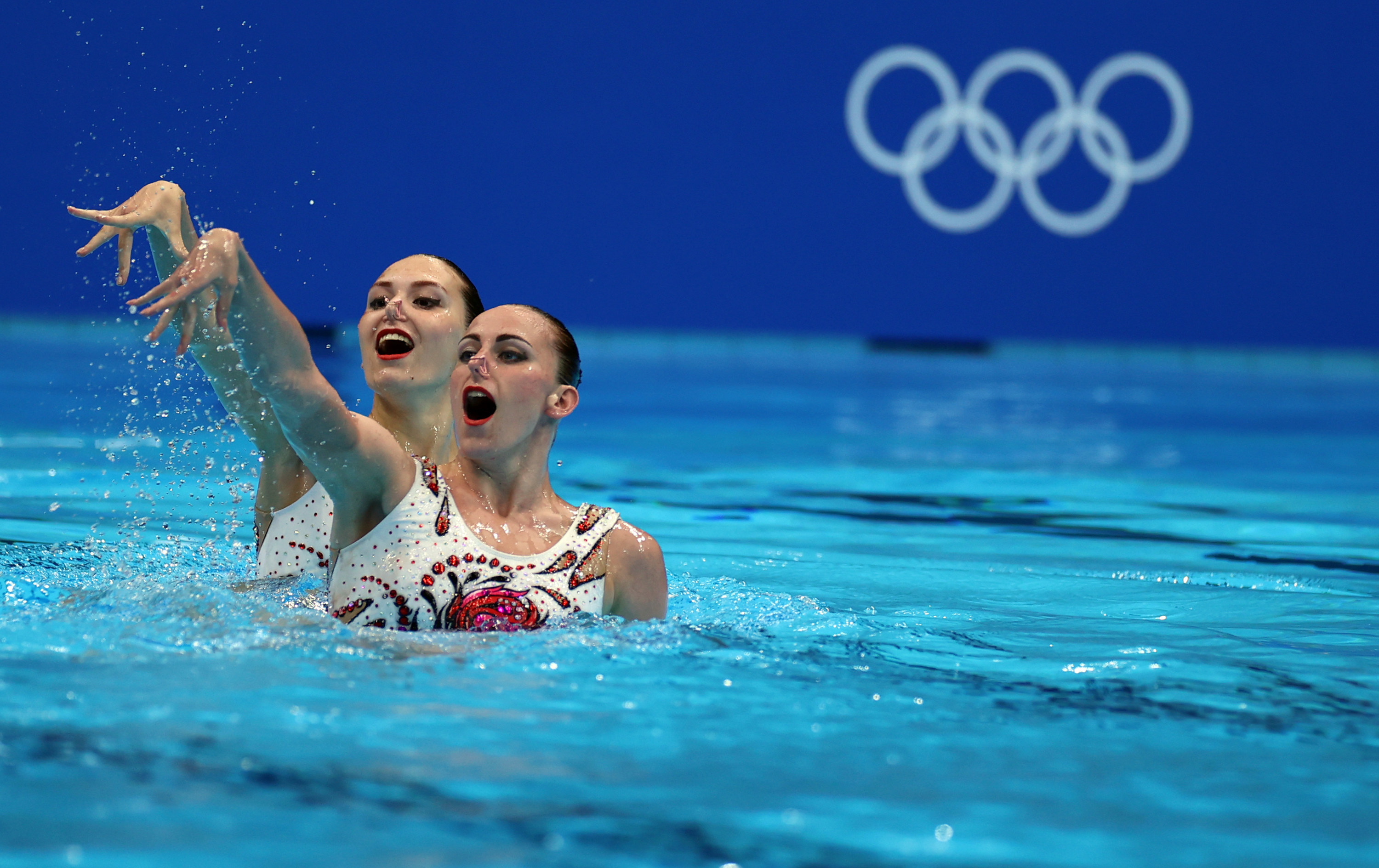 Two swimmers perform in the pool at the Tokyo Olympics