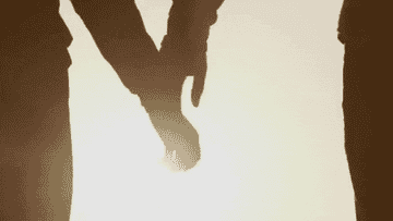 Silhouette of two hands joining together