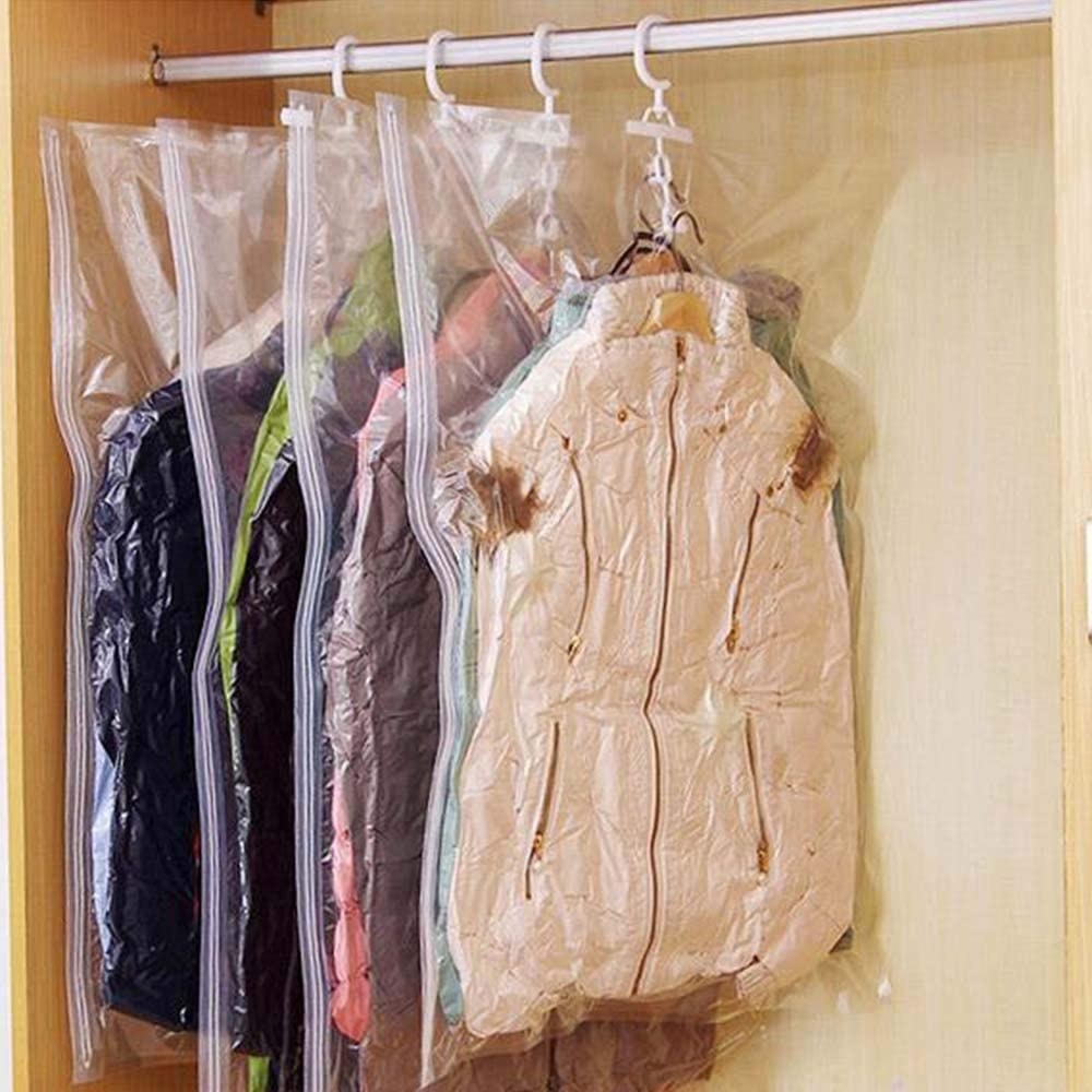 Several airtight storage bags hung up in a closet