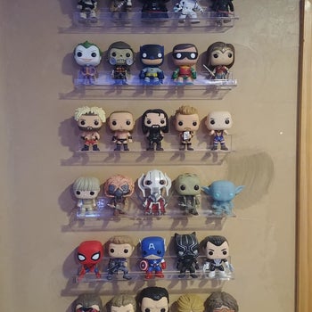 Reviewer's photo showing their funko pops displayed on the invisible floating shelves attached to the wall