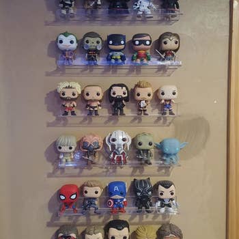 Reviewer's photo showing their funko pops displayed on the invisible floating shelves attached to the wall