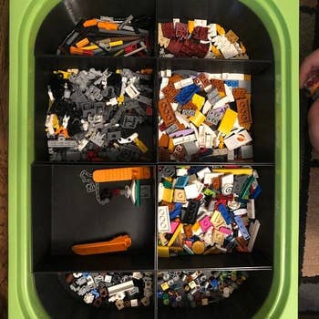 Reviewer's photo showing a storage bin within an Ikea Trofast bin with compartments containing legos