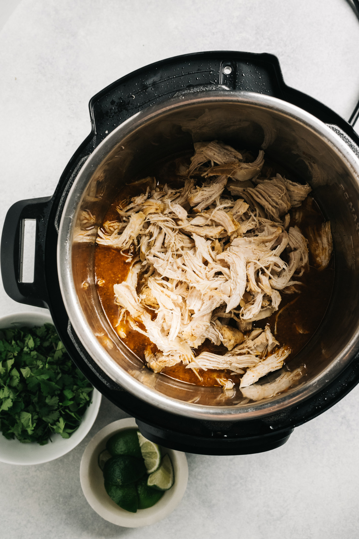 Shredded chicken in a slow cooker.