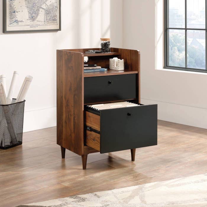 the walnut finish file cabinet with extended black drawer