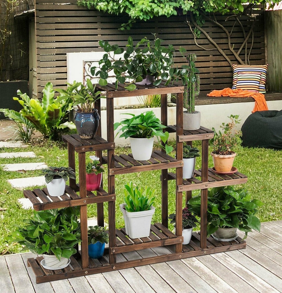 the wood plant stand with several plants on it