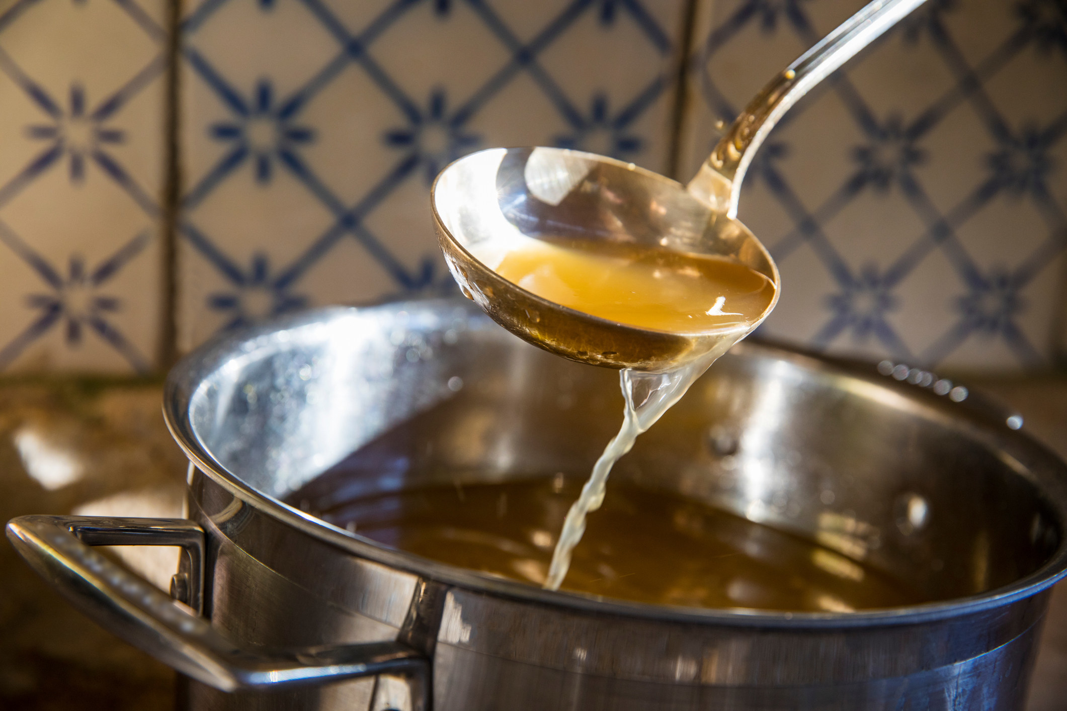 Broth in a ladle.