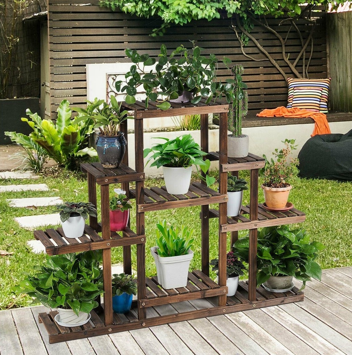 the plant stand outside with several plants on it