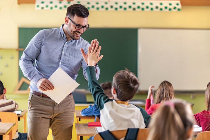 Teacher giving student high-five