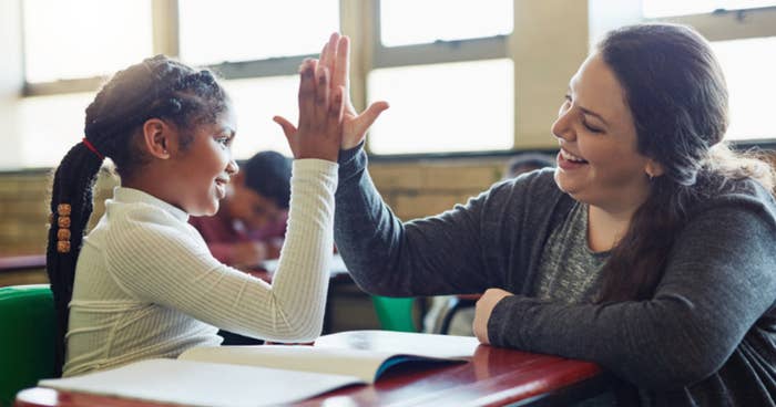 Teacher and student high-fiving