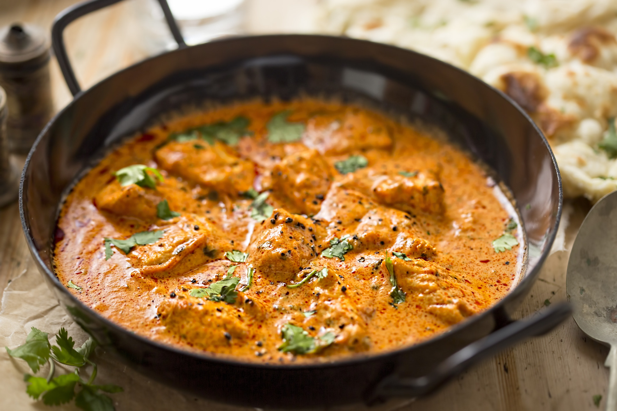 A skillet of butter chicken.