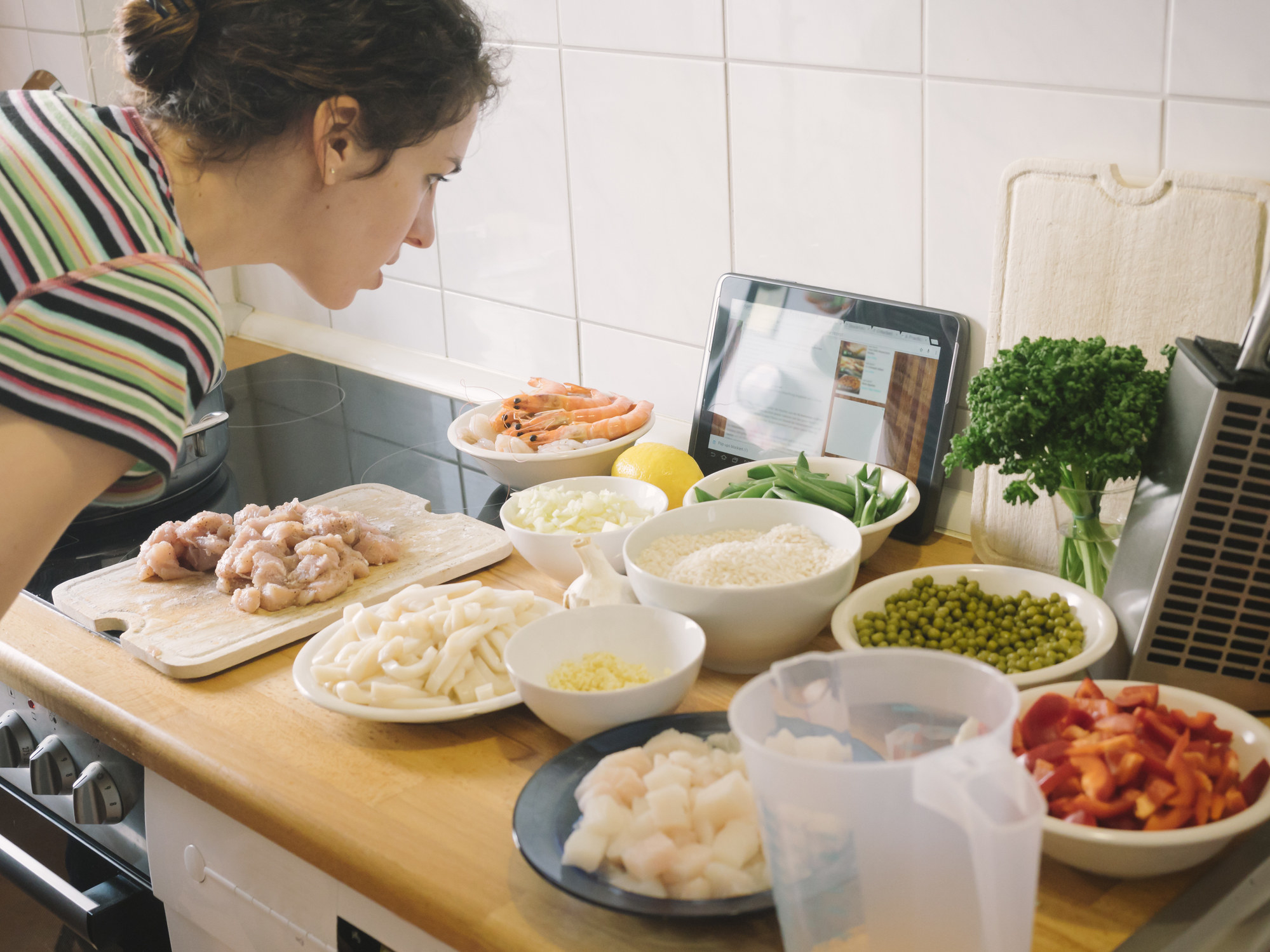 A woman reading an online recipe.