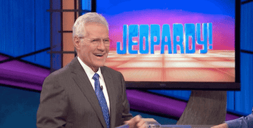 Alex Trebek clapping and smiling on the set of &quot;Jeopardy!&quot;