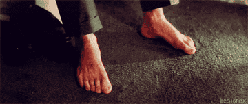 Guy wiggling his toes against a carpet